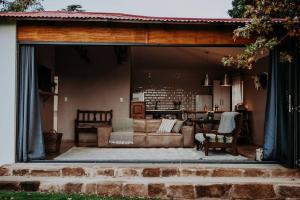a living room with a couch and a table at Sorgenfri in Hendrina