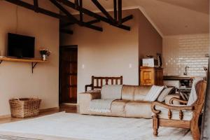 a living room with a couch and a tv at Sorgenfri in Hendrina