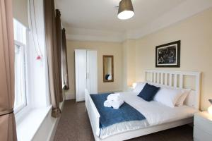 a bedroom with a bed with a teddy bear on it at Brewhouse and Kitchen in Bournemouth