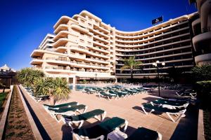 
a large building with a lot of tables and chairs at Vila Gale Marina in Vilamoura
