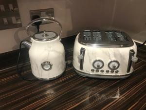 two toasters sitting on top of a counter at Stunning 2-Bed Apartment in Newton Abbot in Newton Abbot