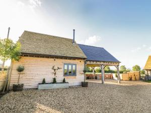 a wooden house with potted plants in front of it at The Hyde in Stratford-upon-Avon