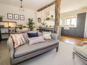 a living room with a couch with pillows on it at The Hyde in Stratford-upon-Avon