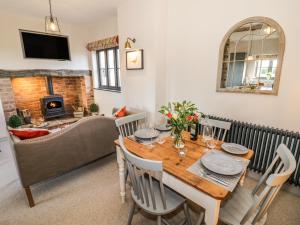 a dining room with a table and a couch at The Hyde in Stratford-upon-Avon