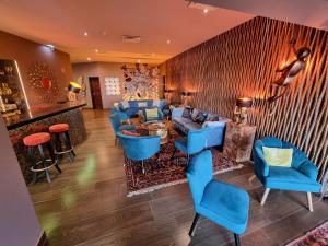 a lobby with blue chairs and a bar at Boutique Hotel Vivenda Miranda in Lagos
