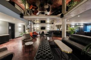 a lobby with a couch and chairs and a bar at Hotel Residenz Pforzheim in Pforzheim