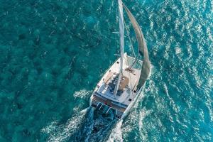 a boat in the water in the ocean at En Plo Boutique Suites in Oia