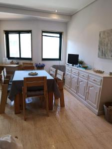 a kitchen and dining room with a table and chairs at Samil 2J in Vigo