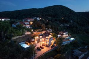 an aerial view of a house with a mountain at Apartment Sandra in Supetarska Draga
