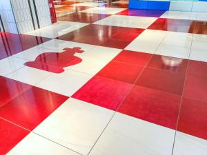 a red and white checkered floor with a shadow on it at Comfort Suites Tokyo Bay in Urayasu