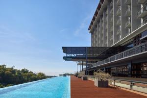 a building with a river in front of it at The Gaia Hotel Bandung in Bandung