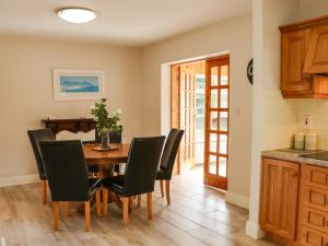 a kitchen and dining room with a table and chairs at Woodlawn in Kilmore