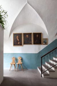 a room with a painting on the wall and a painting on the wall at Goldenstern Townhouse in Bolzano