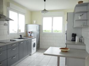 a kitchen with a refrigerator and a table in it at Holiday Home La Roquille by Interhome in Pontaillac