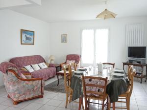 a living room with a table and a couch at Holiday Home La Roquille by Interhome in Pontaillac