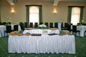 a table with a bunch of food on it at Retro Hotel in Haskovo