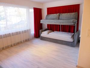 a bedroom with two bunk beds and red curtains at Apartment Andrea B15 by Interhome in Vermala