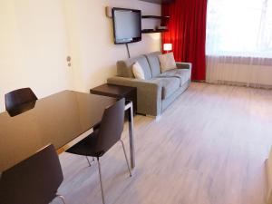 a living room with a couch and a table at Apartment Andrea B15 by Interhome in Vermala