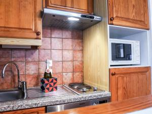 a kitchen with a sink and a microwave at Apartment L'Espace Montagne-5 by Interhome in Chamonix