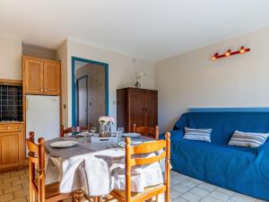 サン・ジョルジュ・ド・ディドンヌにあるHoliday Home L'Orée des Bois by Interhomeのリビングルーム(テーブル、青いソファ付)