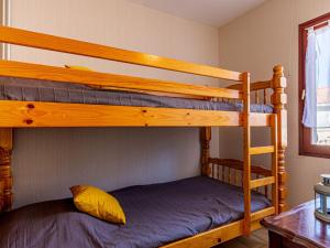 two bunk beds in a room with a table at Holiday Home L'Orée des Bois by Interhome in Saint-Georges-de-Didonne