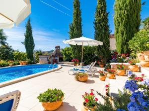a villa with a swimming pool and a garden at Apartment Viktorija - PRC406 by Interhome in Nova Vas