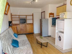 a living room with a couch and a kitchen at Apartment Les Balcons de la Méditerranée-18 by Interhome in Narbonne-Plage