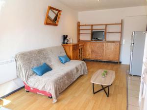 a living room with a couch and a tv at Apartment Les Balcons de la Méditerranée-18 by Interhome in Narbonne-Plage