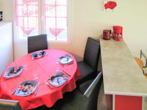 a dining room with a red table and chairs at Holiday Home Horizon by Interhome in Cap-Ferret +15 photos