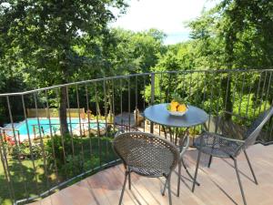 a patio with a table and chairs and a pool at Villa Oleandra sul Lago by Interhome in San Feliciano +42 photos