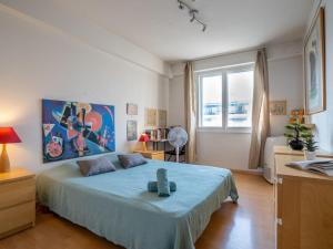 a bedroom with a large bed with a blue blanket at Apartment Copacabana Promenade des Anglais by Interhome in Nice