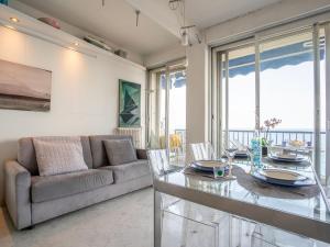 a living room with a table and a couch at Apartment Copacabana Promenade des Anglais by Interhome in Nice