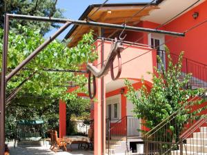 an orange house with a patio and trees at Apartment Bozac - PUL480 by Interhome in Šikići