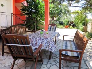 a table with two chairs and a table with a tablecloth on a patio at Apartment Bozac - PUL480 by Interhome in Šikići
