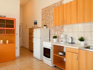 a kitchen with a white refrigerator and a sink at Apartment Marija - BKA501 by Interhome in Jurandvor