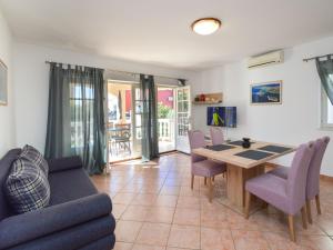 a living room with a dining room table and chairs at Apartment Mladen-1 by Interhome in Vodice