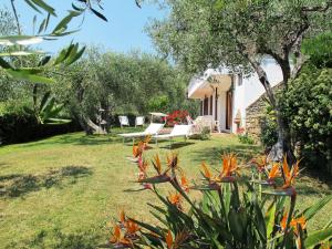 a garden with orange flowers and a house at Apartment Alberto B by Interhome in Diano Castello