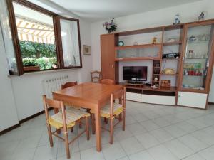 jadalnia z drewnianym stołem i krzesłami w obiekcie Apartment Parco Musadino by Interhome w mieście Porto Valtravaglia