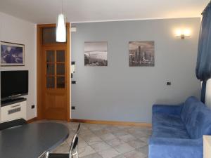 un soggiorno con divano blu e TV di Apartment Schmid by Interhome a Caldonazzo