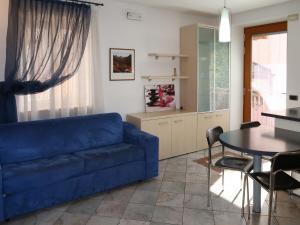 ein Wohnzimmer mit einem blauen Sofa und einem Tisch in der Unterkunft Apartment Schmid by Interhome in Caldonazzo