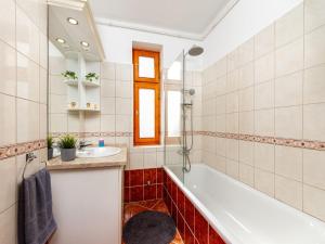 a bathroom with a tub and a sink at Holiday Home Ruby 1 by Interhome in Balatonberény