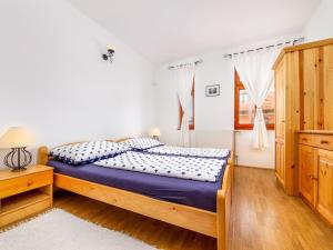 a bedroom with a bed and a window at Holiday Home Ruby 1 by Interhome in Balatonberény