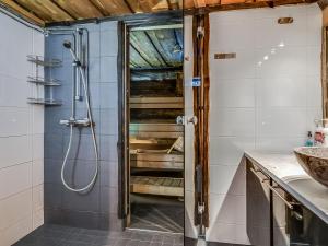 a shower with a glass door in a bathroom at Holiday Home Seitsemän savua 6 by Interhome in Ruka