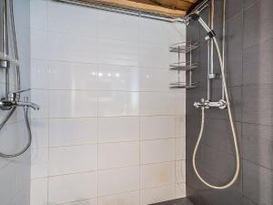 a shower with a hose in a bathroom at Holiday Home Seitsemän savua 6 by Interhome in Ruka