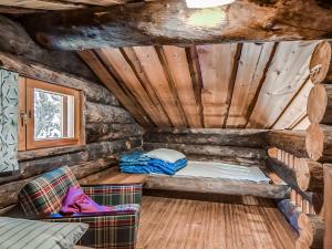 a small room with a bed in a log cabin at Holiday Home Seitsemän savua 6 by Interhome in Ruka