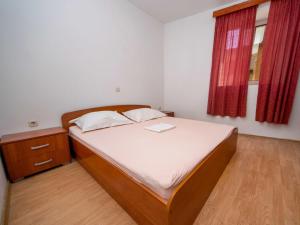 a small bedroom with a bed and a window at Holiday Home Repak by Interhome in Brna +6 photos