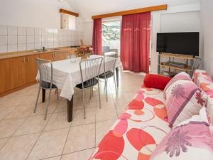 a living room with a couch and a table with chairs at Holiday Home Repak by Interhome in Brna