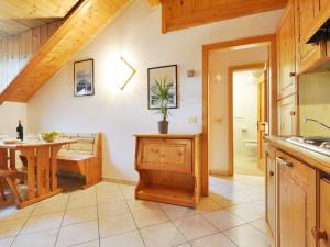 a kitchen with a table and a dining room at Apartment Villa Placidia Apt 32 by Interhome in Campitello di Fassa +28 photos