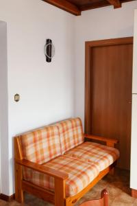 a couch sitting in the corner of a room at Apartment Brida by Interhome in Caldonazzo