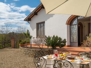 a patio with a table with food on it at Holiday Home Melograno by Interhome in Terranuova Bracciolini